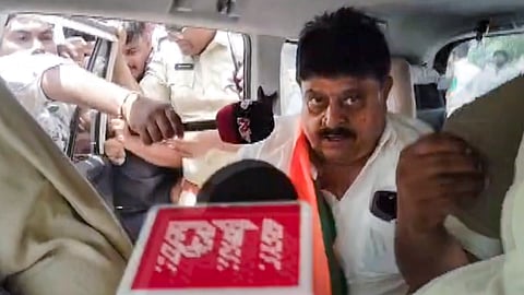 Telangana BJP President N. Ramchander Rao inside a police vehicle after being detained during a protest demanding the release of pending fee reimbursement dues for students