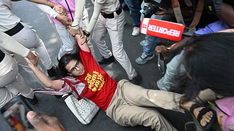 Neha Bora being detained during a protest at Jantar Mantar, in New Delhi, on Friday | PTI