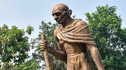 A worker cleans a statue of Mahatma Gandhi ahead of Gandhi Jayanti celebrations at Gandhi Mandap, in Guwahati, on Thursday | PTI