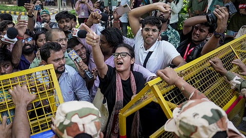 AISA National President Neha Bora along with other protestors raise slogans during a protest against CEC Gyanesh Kumar, in New Delhi, on Saturday | PTI