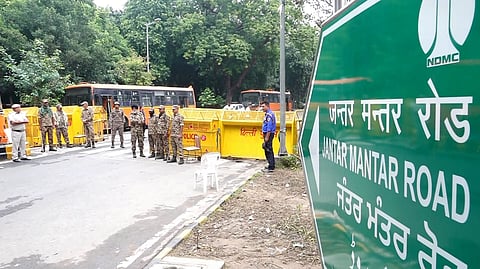 Police personnel stand near barricades ahead of a Tiranga March rally by Cockroach Janata Party, at Jantar Mantar, in New Delhi, on Friday | PTI