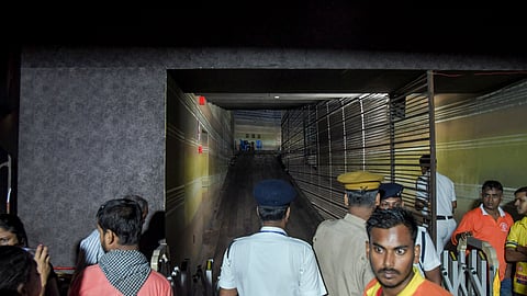 Security and police personnel control the area outside a Durga Puja pandal after the exit gate collapsed due to heavy crowd pressure, in Kolkata, on Saturday | PTI