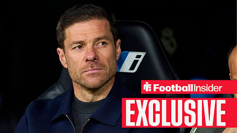 Football Insider exclusive as Chelsea manager Xabi Alonso stares into the distance while sitting on the bench.