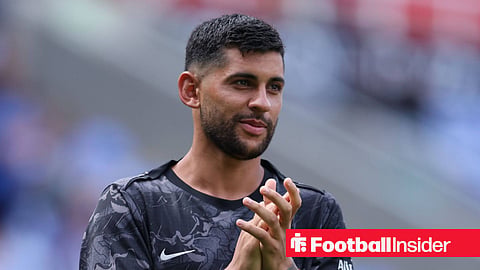 Tottenham defender Cristian Romero claps and smiles