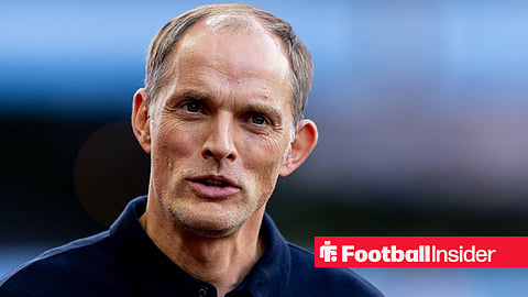 Thomas Tuchel smiling on sidelines looking forward with head tilted