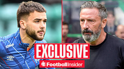 Nicolas Raskin warming up for Rangers facing right with tongue out and Derek McInnes looking sternly back at him on the sidelines