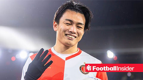 Ayase Ueda celebrating with the ball in his hand after scoring for Feyenoord