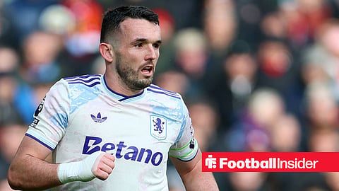 John McGinn in action for Aston Villa looking right with right hand up in a cast
