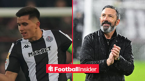 Vanja Dragojevic playing for Partizan Belgrade on left and Derek McInnes clapping hands in rain on right