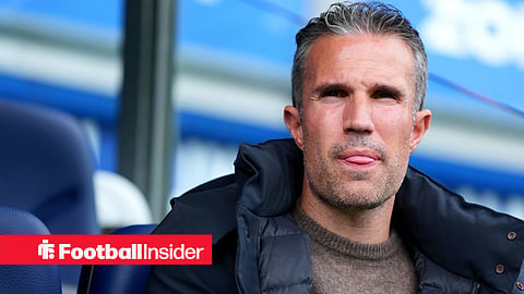 Robin van Persie in jumper and coat in dugout