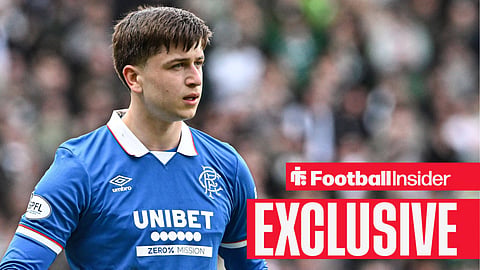 Mikey Moore in blue Rangers home shirt holding football