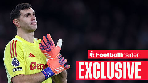 Emi Martinez holding glove in Aston Villa kit
