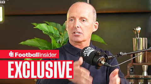 Ex-Premier League referee Mike Dean speaks into a podcast microphone