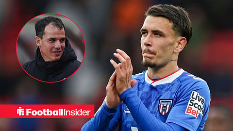 Enzo Le Fee with hands together with Regis Le Bris left inset on sideline