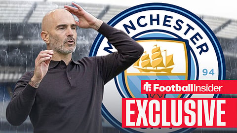 Man City manager, Enzo Maresca, looking nervous at the Etihad Stadium, with a Man City badge behind him