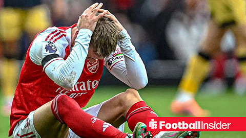 Arsenal captain Martin Odegaard covers his face after suffering an injury in 2025-26