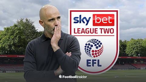 A disappointed-looking Enzo Maresca at Salford City stadium, AIG Stadium, with a League Two badge behind him