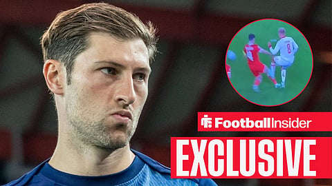 Tottenham Hotspur defender Ben Davies looks on in North London / Ben Davies tackles Gustav Isaksen after his shot in Wales vs Denmark on 4 October 2026