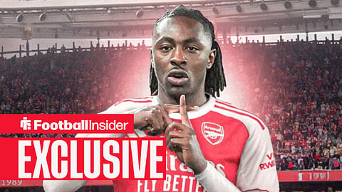 Arsenal midfielder Eberechi Eze celebrates with Emirates Stadium behind