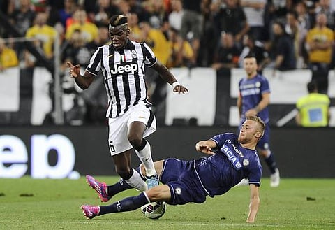 Juventus' Paul Pogba (L) fights for the ball with Udinese's Silvan Widmer during their Italian Serie A soccer match at Juventus Stadium in Turin September 13, 2014. REUTERS/Giorgio Perottino (ITALY - Tags: SPORT SOCCER) 
Picture Supplied by Action Images