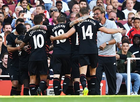 LONDON, ENGLAND - AUGUST 14:  Sadio Mane (2ndL) of Liverpool and team mates celebrate his goal with Jurgen Klopp, Manager of Liverpool during the Premier League match between Arsenal and Liverpool at Emirates Stadium on August 14, 2016 in London, England.  (Photo by Michael Regan/Getty Images)