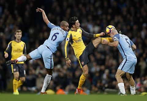 Britain Football Soccer - Manchester City v Arsenal - Premier League - Etihad Stadium - 18/12/16 Arsenal's Mesut Ozil in action with Manchester City's Pablo Zabaleta and Fernando  Action Images via Reuters / Carl Recine Livepic EDITORIAL USE ONLY. No use with unauthorized audio, video, data, fixture lists, club/league logos or "live" services. Online in-match use limited to 45 images, no video emulation. No use in betting, games or single club/league/player publications. Please contact your account representative for further details.