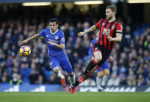 Britain Soccer Football - Chelsea v AFC Bournemouth - Premier League - Stamford Bridge - 26/12/16 Chelsea's Pedro in action with Bournemouth's Simon Francis Reuters / Peter Nicholls Livepic EDITORIAL USE ONLY. No use with unauthorized audio, video, data, fixture lists, club/league logos or "live" services. Online in-match use limited to 45 images, no video emulation. No use in betting, games or single club/league/player publications. Please contact your account representative for further details.