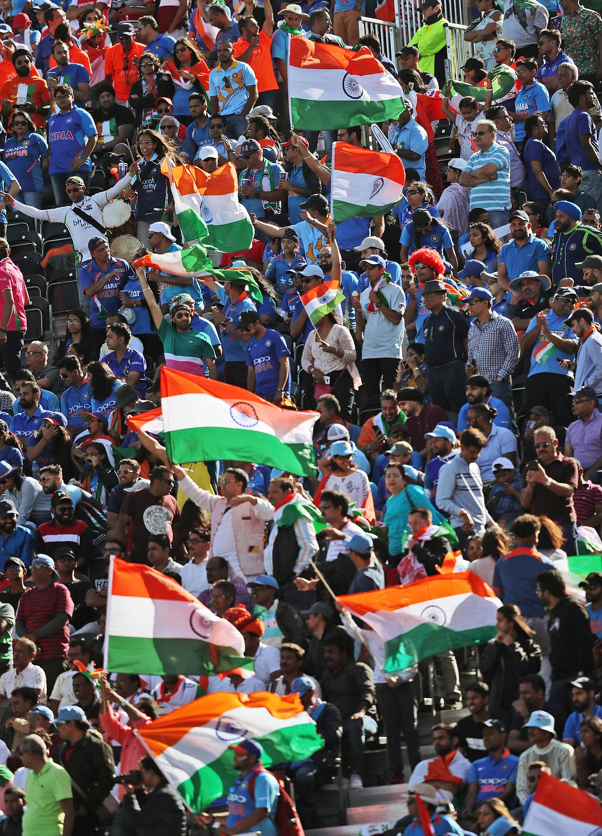 Indian cricket fans wave their national flags during the Cricket World Cup match between West Indies' and India