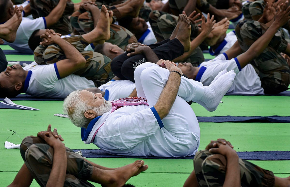 Prime Minister Narendra Modi along with other participants performs yoga during a mass yoga event organised to mark the 5th International Day of Yoga, at Prabhat Tara Ground in Ranchi.