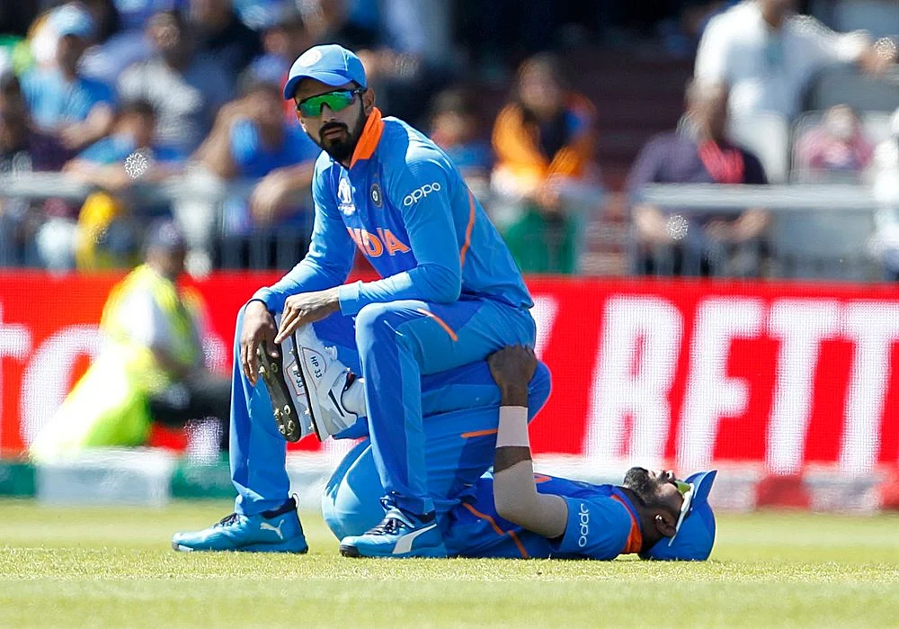 Indian players Lokesh Rahul and Hardik Pandya stretch during the match against West Indies