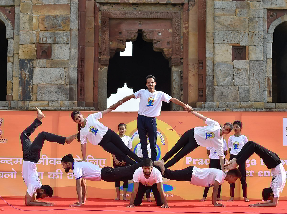 Participants perform at a mass yoga session organised to mark the 5th International Day of Yoga, at Lodhi Gardens in New Delhi