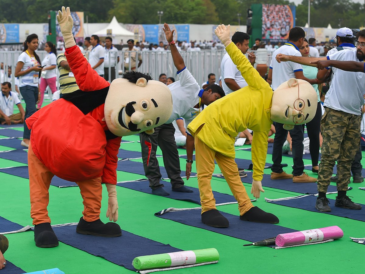 Indian animated characters Motu Patlu perform yoga during a mass yoga event on the 5th International Day of Yoga at Prabhat Tara ground, in Ranchi.
