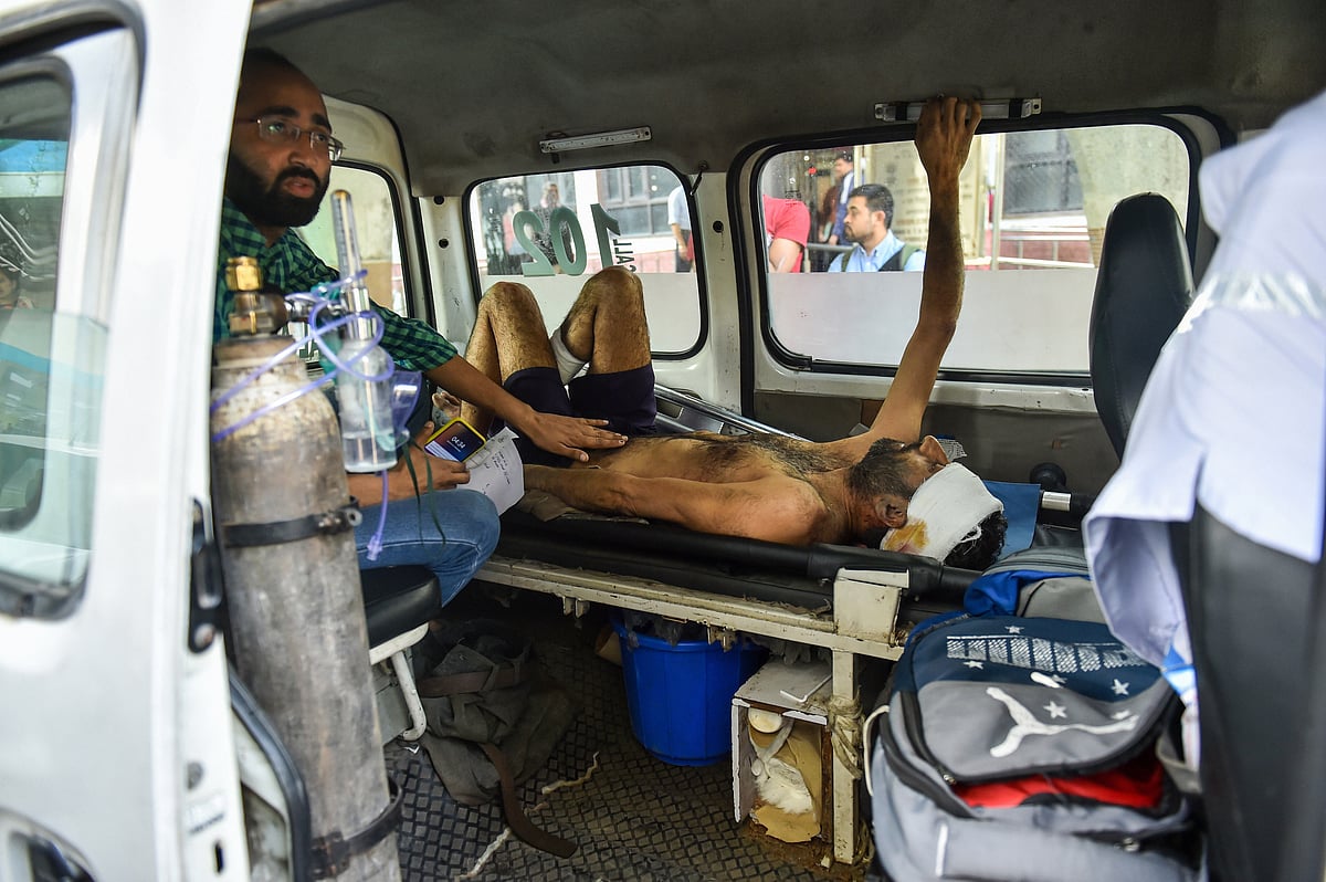 A man injured during communal violence over the amended citizenship law in the riot-affected north east Delhi, being brought to GTB hospital for treatment, in east Delhi, Wednesday, Feb. 26, 2020.
