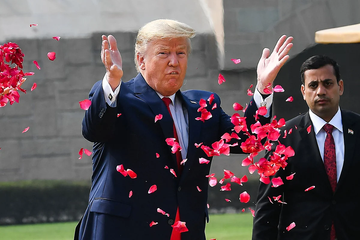 US President Donald Trump sprays rose petals to pay tribute at Raj Ghat, the memorial for Indian independence icon Mahatma Gandhi, in New Delhi on February 25, 2020