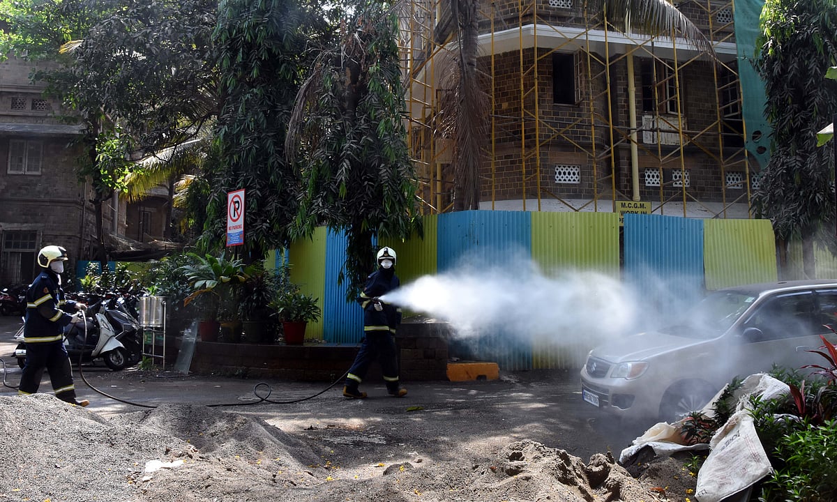 Mumbai fire brigade personnel sanitize area outside KEM Hospital 