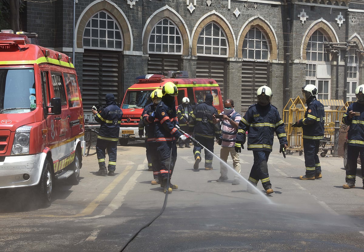 Firebrigade workers splashing water outside BMC office