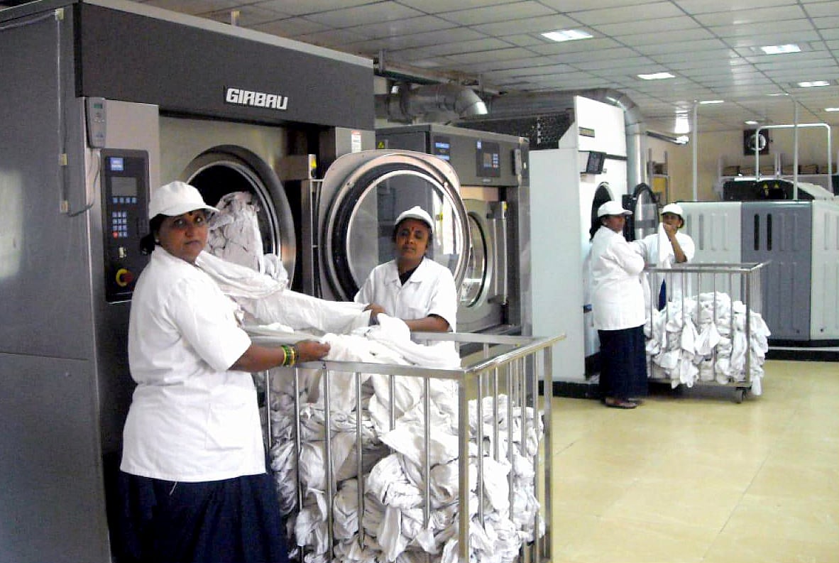 Railway staffs wash blankets at a laundry, in Mumbai