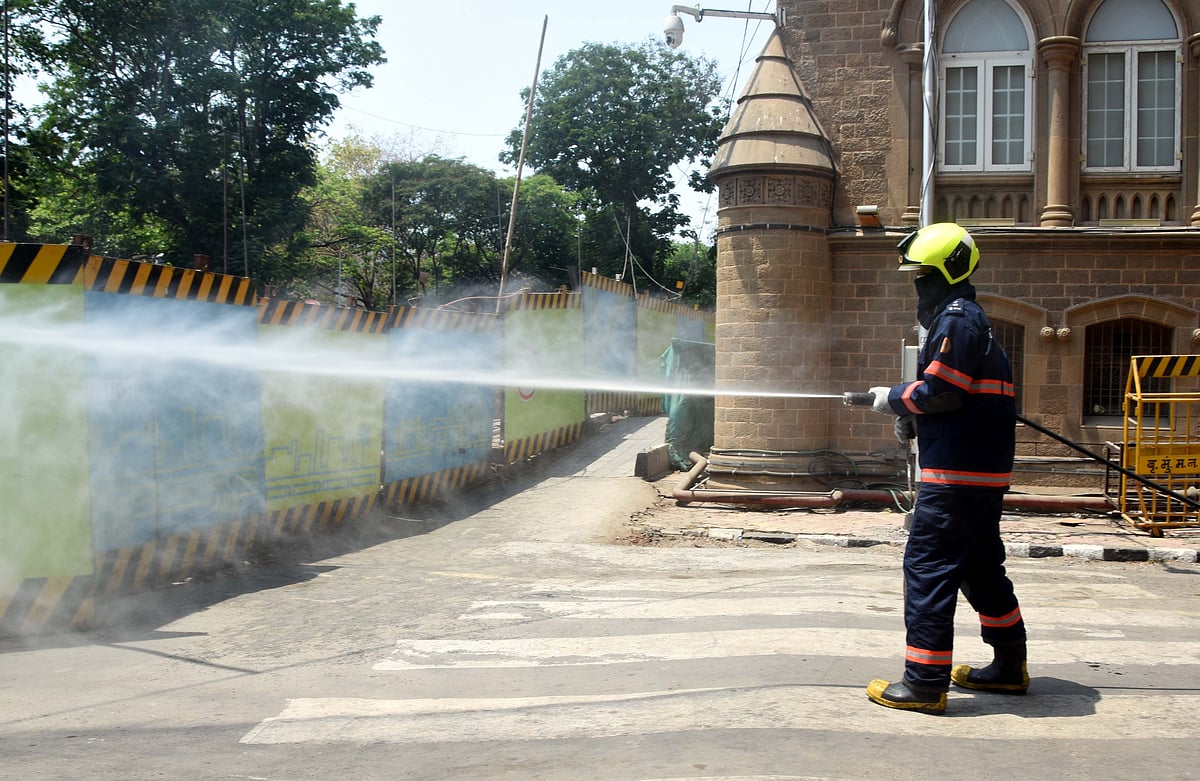 Firebrigade workers splashing water outside BMC office
