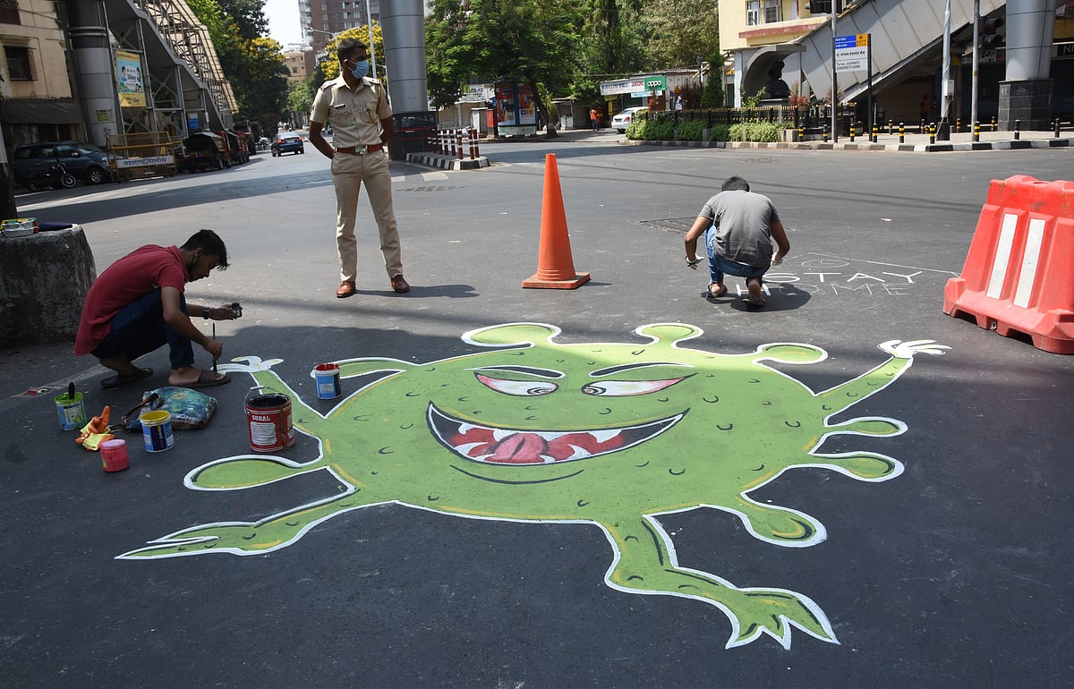 A man painting coronvirus' painting below Grant Road skywalk.