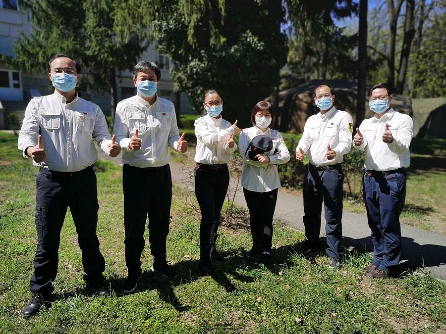 Members of Chinese medical expert team to Serbia pose for a group photo at their residence in Belgrade, Serbia, April 12, 2020.