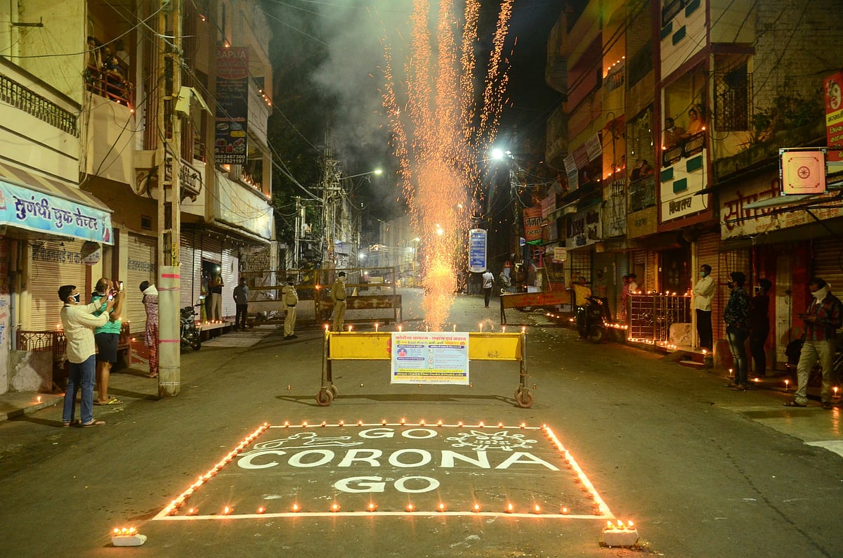 People bursting crackers on the middle of road after lighting diyas in Sarafa area. 