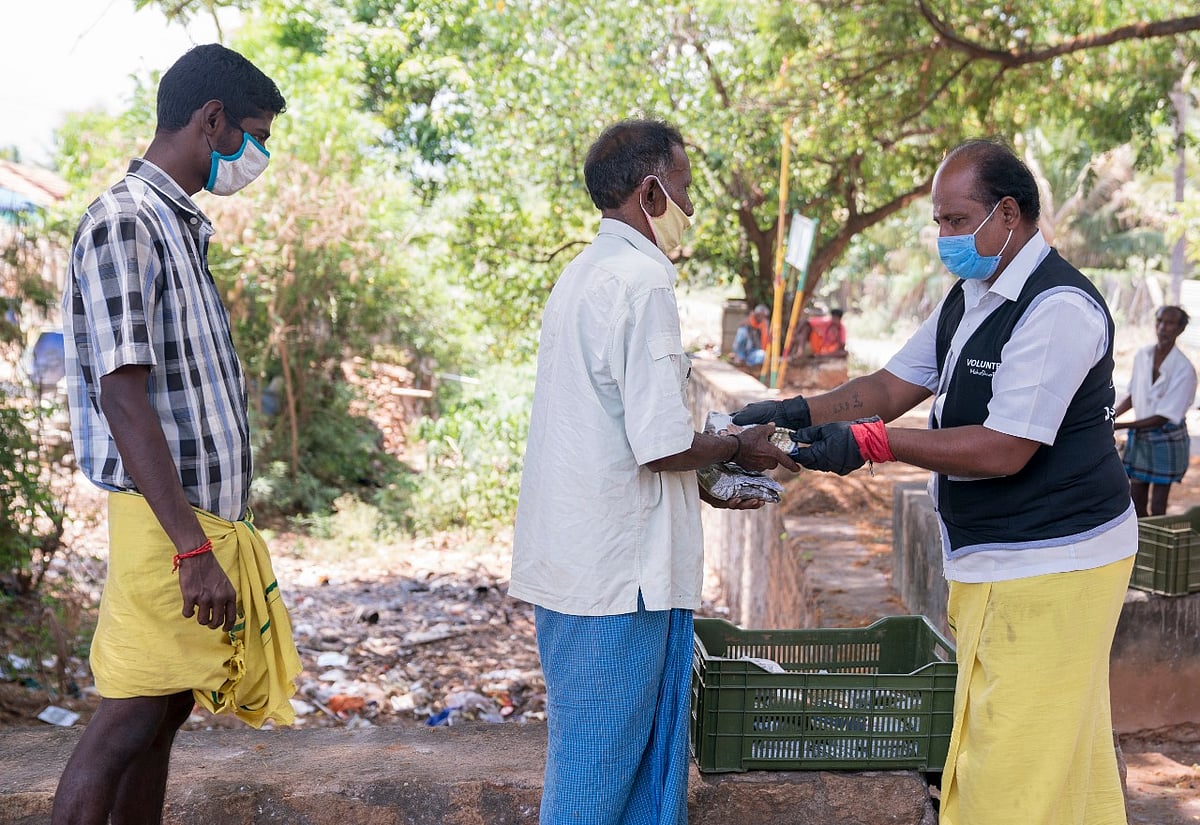Isha Foundation volunteers distributing food and other essentials to people in need