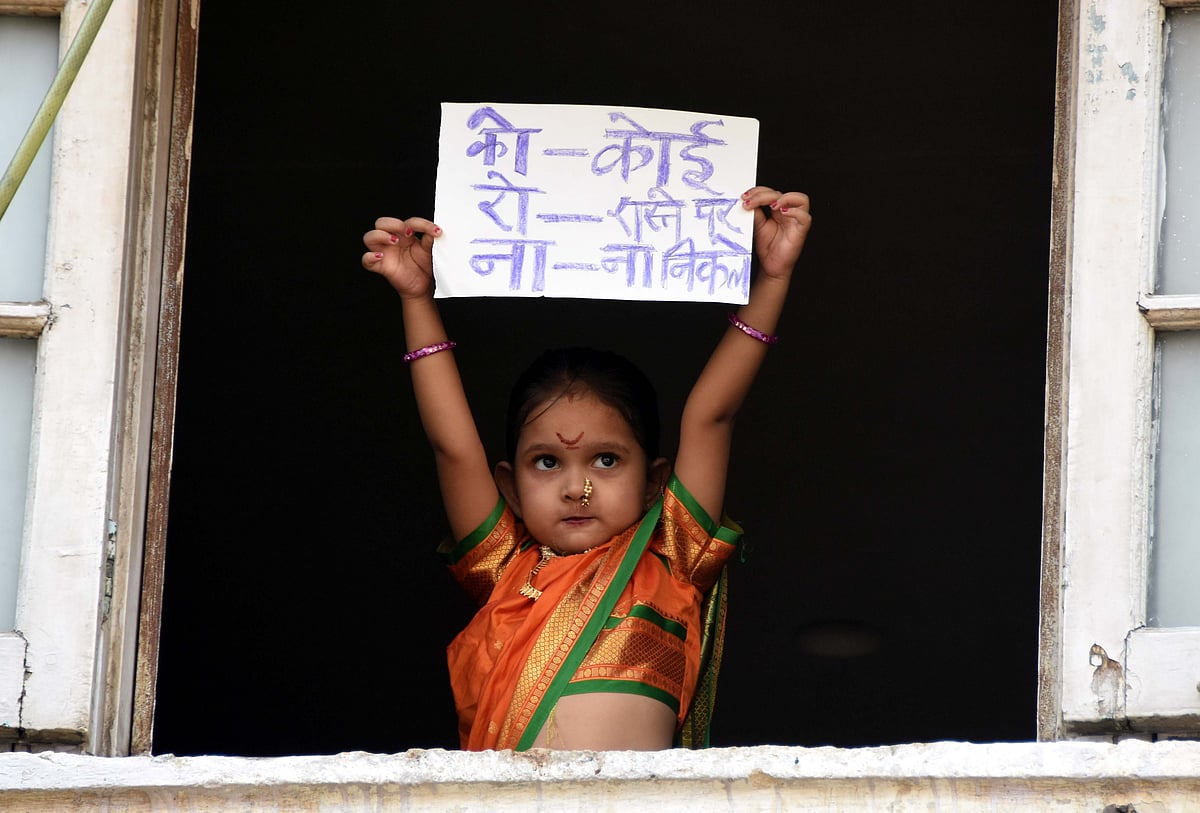 A little girl holds up a sign