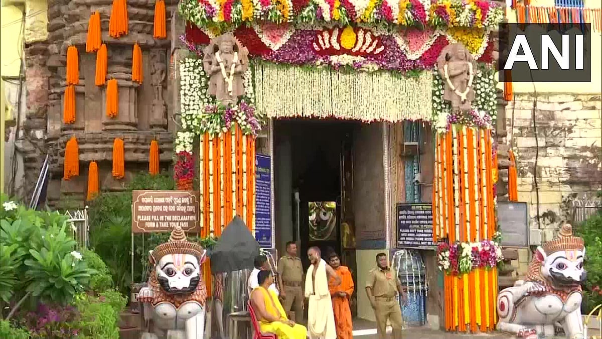 Priests and security personnel outside the temple.