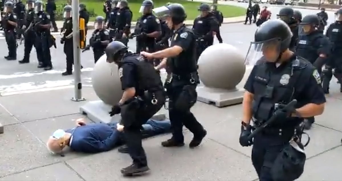 A 75-year-old protester falls to the ground after being shoved by Buffalo, New York, police, on June 4, 2020, after Buffalos curfew went into effect, according to media reports.