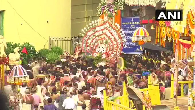 Idol of Lord Balabhadra being brought to chariot by priests and 'sevayats' for the Rath Yatra from Jagannath Temple in Puri.
