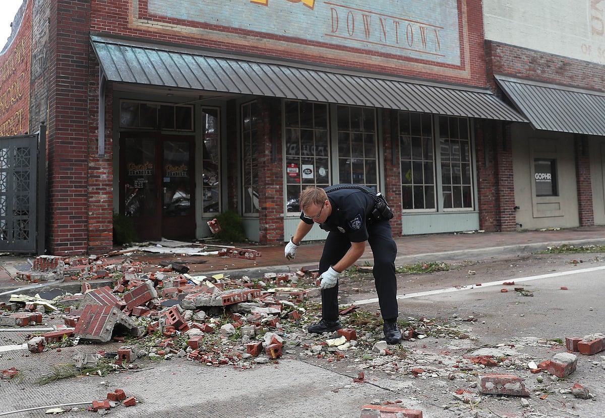 A Lake Charles police officer helps clear the streets in the downtown area after Hurricane Laura passed through on August 27, 2020 in Lake Charles, Louisiana