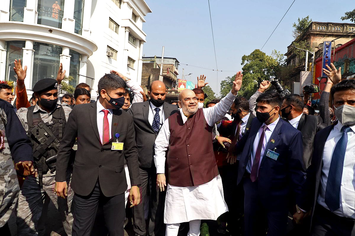 Union Home Minister Amit Shah waves to supporters during his visit to Swami Vivekanand ancestral house at Ramakrishna Ashram in Kolkata on Saturday.