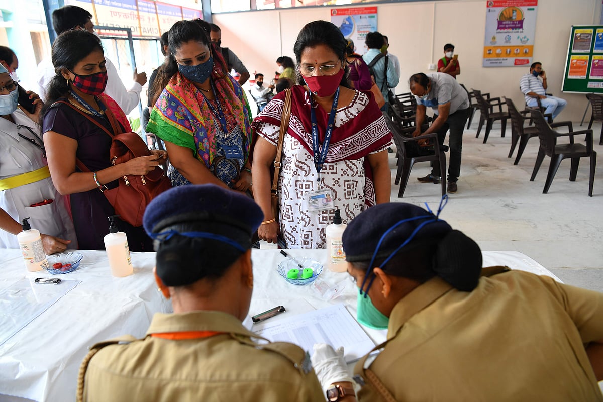 Health workers in line to receive the Covid-19 coronavirus vaccine verify their identities at a vaccination centre in the Rajawadi Hospital in Mumbai on January 16, 2021.