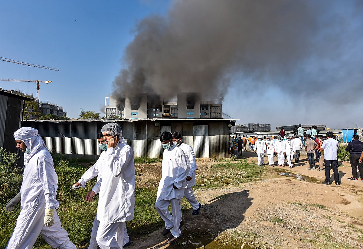Pune: Workers of Serum Institute of India come out of the building after fire broke out in it, in Pune, Thursday, Jan. 21, 2021